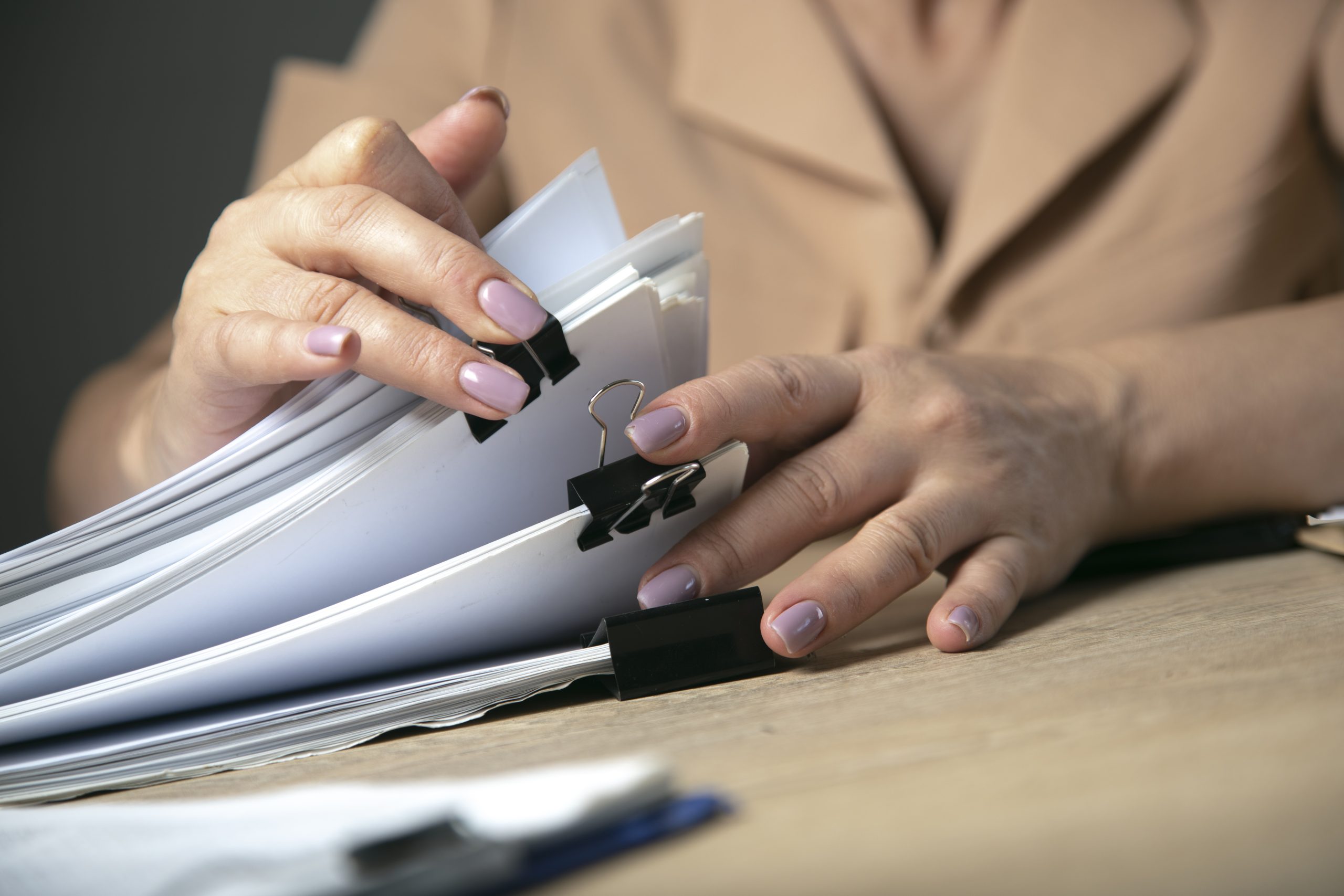 woman holding stack of files