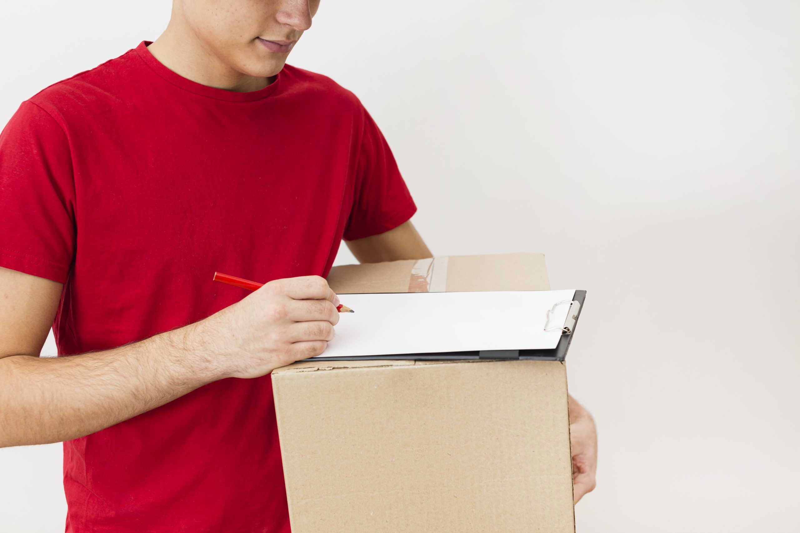 close-up-delivery-man-signing-delivery-package